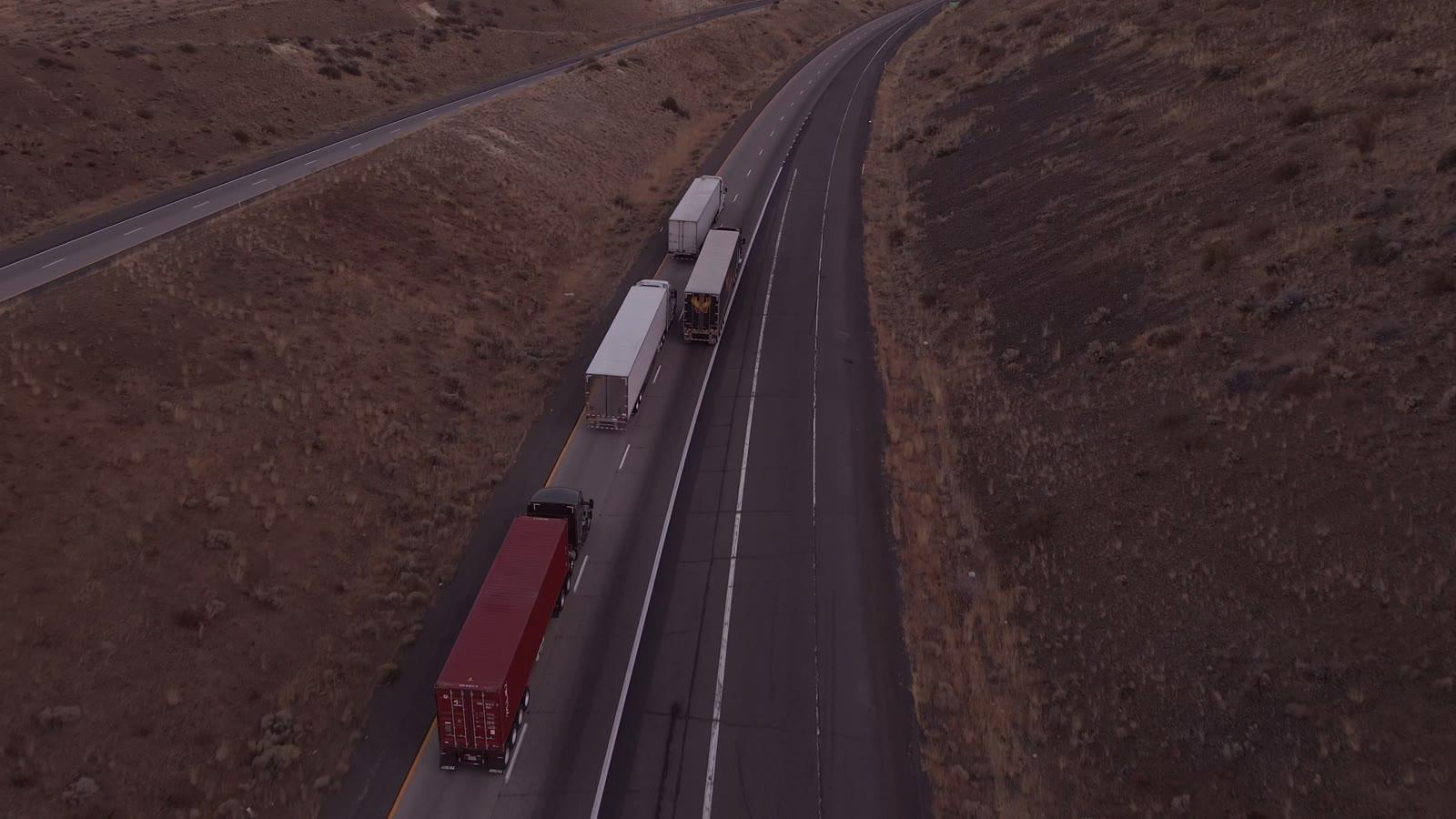 Semi trucks on a highway, seen from above